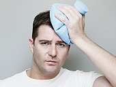 Man Holding Ice Pack On Head.